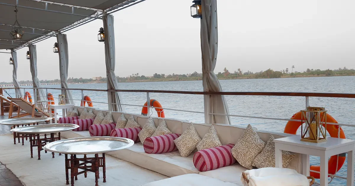 The Altesse Dahabiya sailboat using its two large white sails on the Nile River.