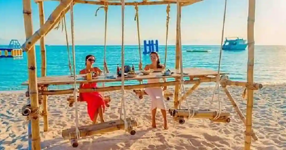 Hula Hula Beach Island swings over turquoise water