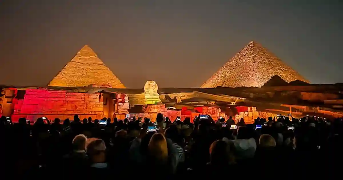 Visitors watching the sound and light show at Giza pyramids