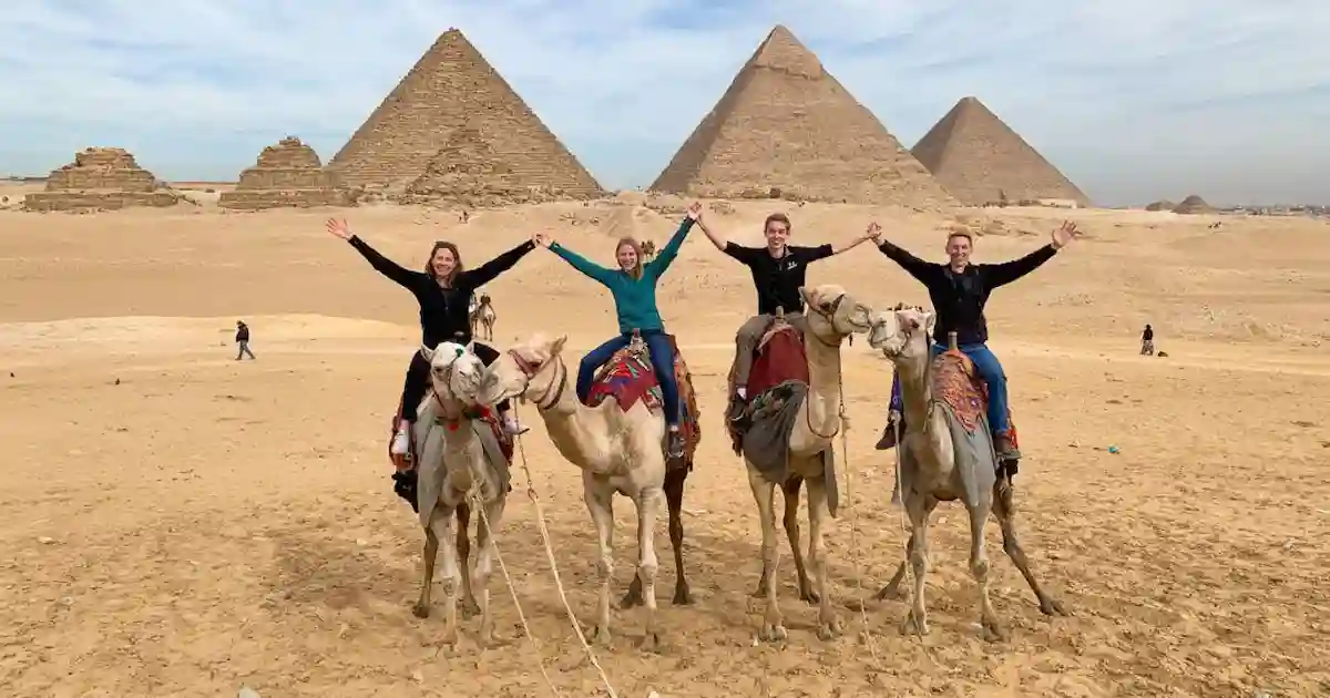 Camel rides beside Giza pyramids and Sphinx